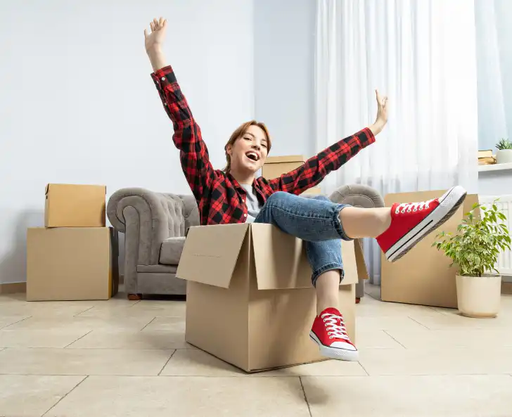 Happy young woman moving